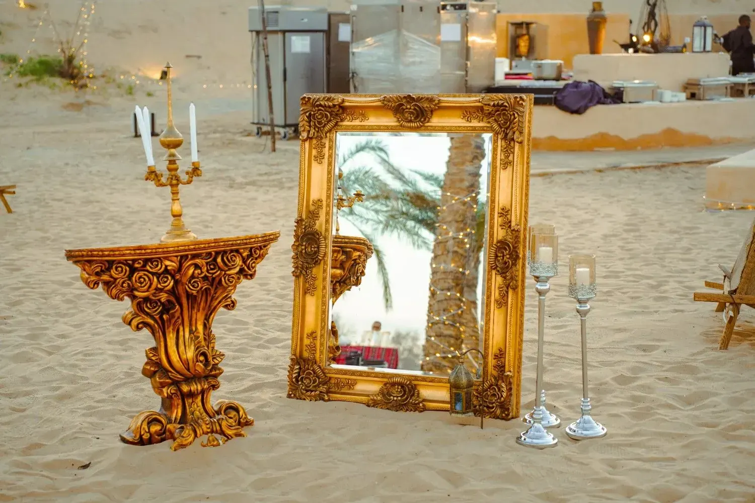 Gilded mirror and candelabra in the sand