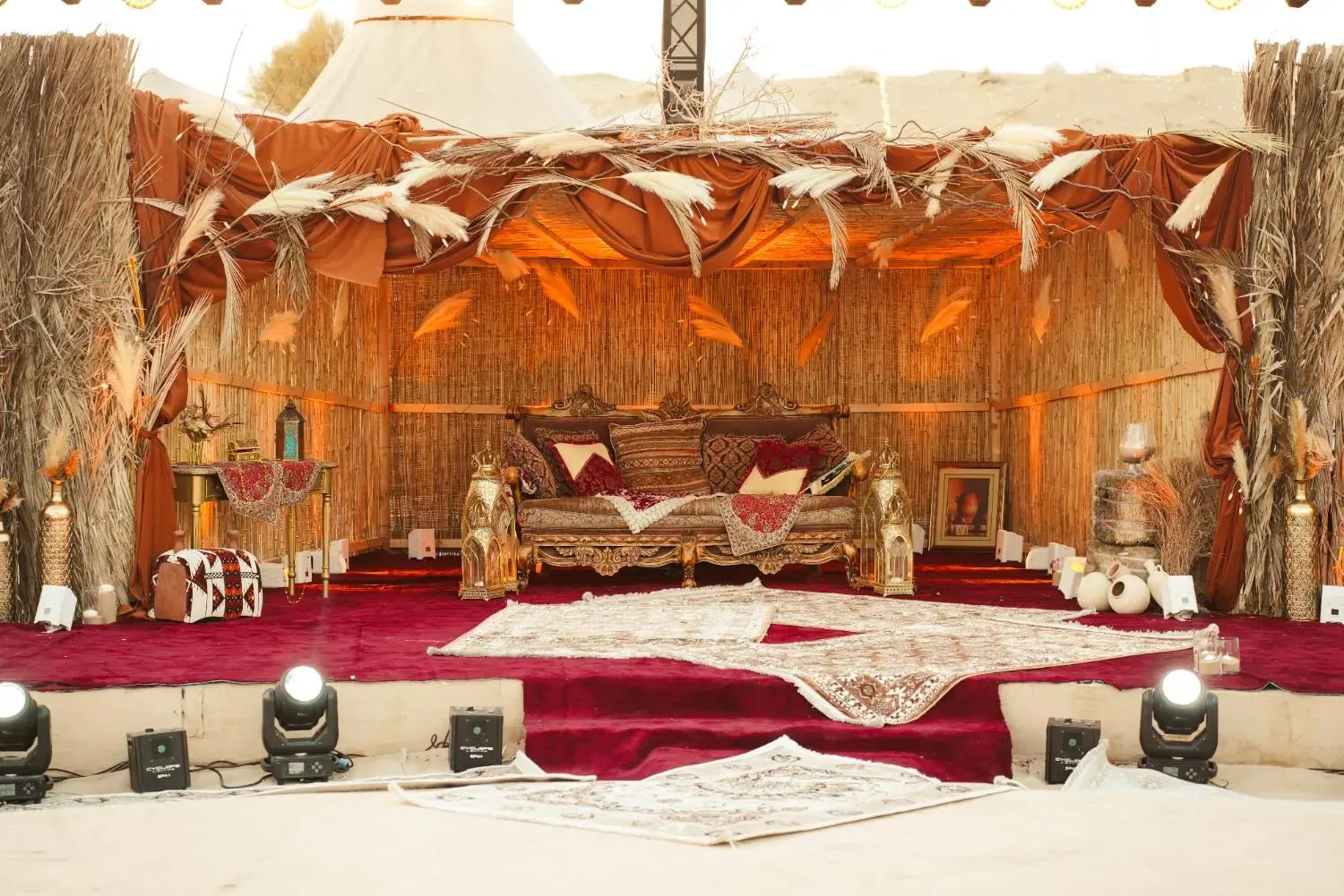 Palm-frond and brass stage at a desert wedding in Al Khatim